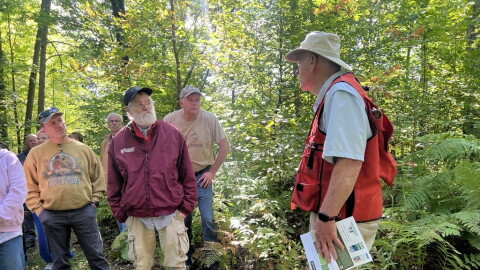 Gary Anderson speaks to a crowd touring his property Sept. 12 near Outing. 