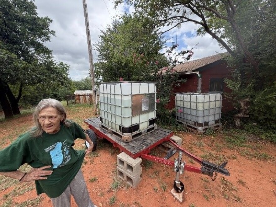 Cedar Lake resident Belinda Smith talks about her 275-gallon water tank donated by neighbors at her rented house on Thursday, July 16, 2026. Smith hasn't had reliable running water for two years but can't afford to move.