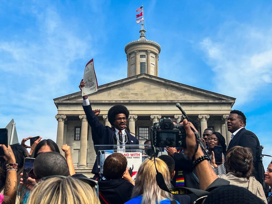 Rep. Justin J. Pearson raises the Oath of Office in the air after being sworn in.