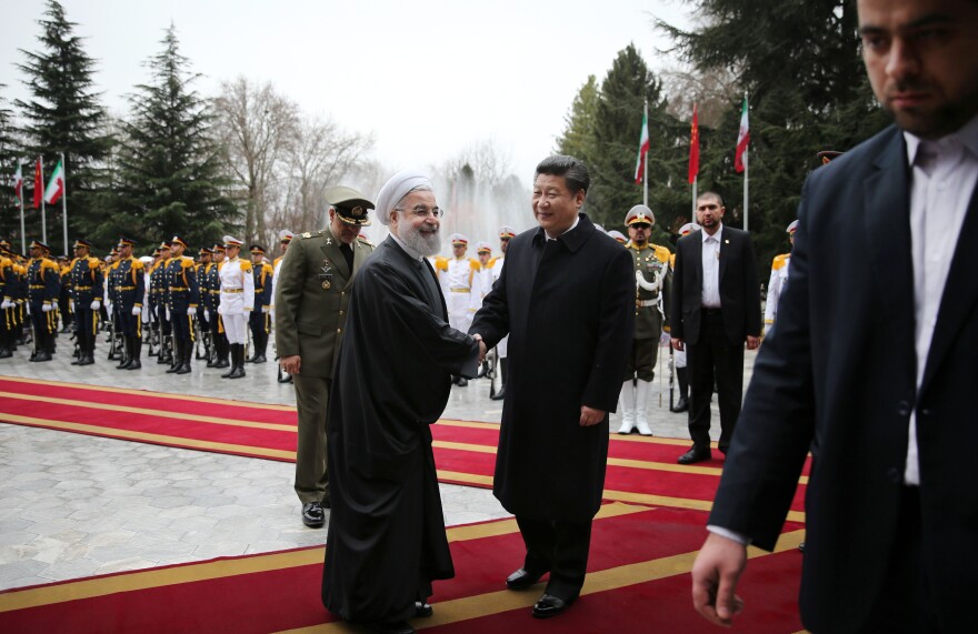 Iranian President Hassan Rouhani greets visiting Chinese President Xi Jinping at the Saadabad Palace in Tehran on Saturday. With sanctions lifted, the countries pledged to develop economic ties.
