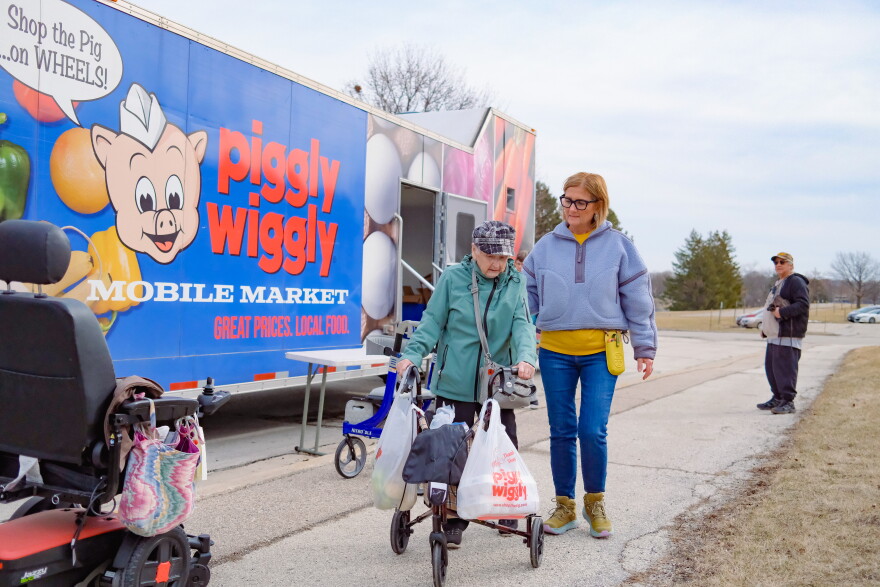 Shopper leaving Mobile Market.