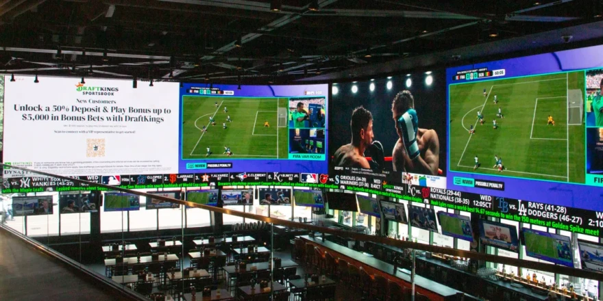 A massive 2,000-square-foot television wraps around the DraftKings Sports Bar at Wrigley Field.