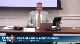 Commissioner seated at dais