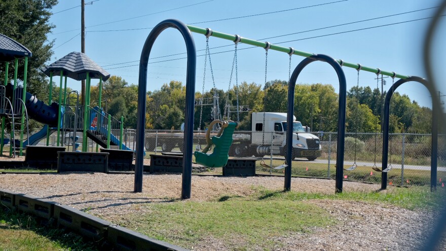 An 18-wheeler drives by the playground at Holly Ridge Elementary School in Holly Ridge, Louisiana, on Friday, October 17, 2025. The school shut down the playground this year over safety concerns due to trucks heading to the Meta construction site, less than a mile away from the school.