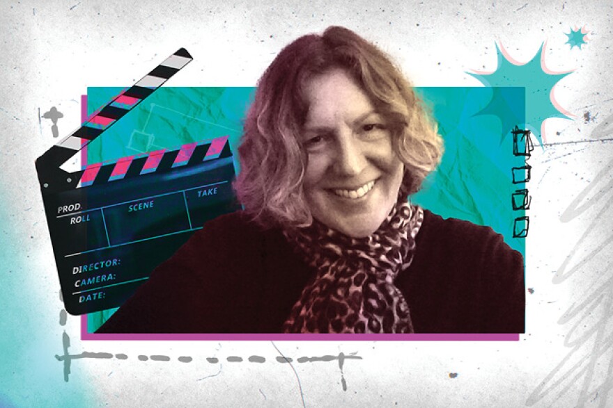 Andi Isaacs smiles in front of colorful illustrations and a clapperboard