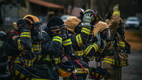 Firefighters don personal protective equipment during a training exercise outside Spokane County Fire District 9.