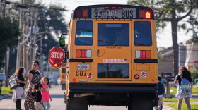 Children disembark from a school bus.