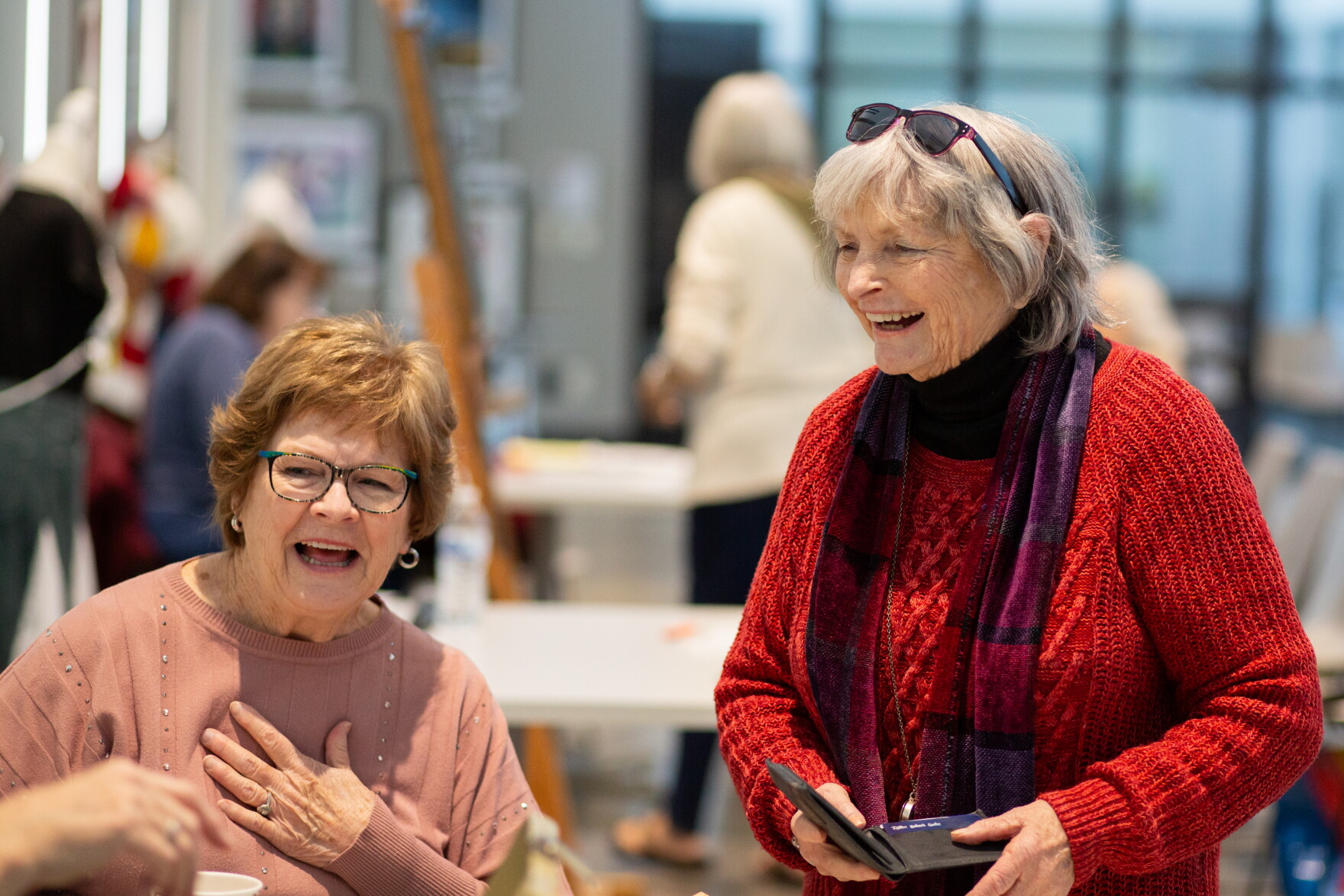 Judi Michaelis and Lyda Andrews laugh with another Wichita Women Artists member at the group's monthly meeting on March 20. WWA is celebrating its 75th anniversary.
