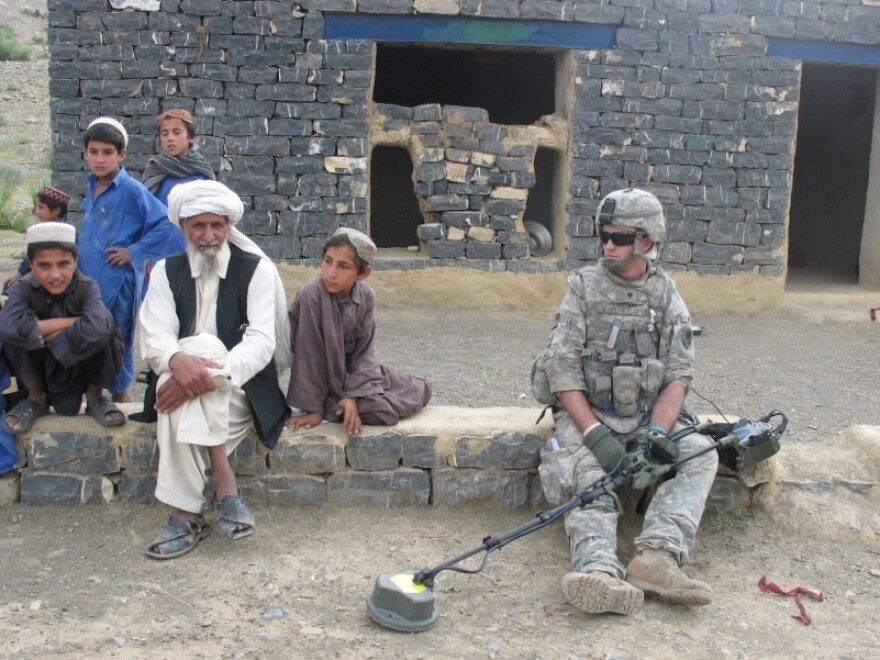 Spc. Dominic Fredianelli rests during a cache sweep in an Afghan village.