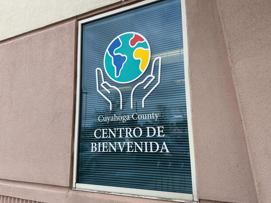 Exterior window of Cuyahoga County Welcome Center with Spanish writing