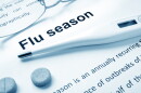Flu season sign and a thermometer