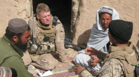 Marine Lt. Col. Brian Christmas listens as an interpreter translates the concerns of Marjah residents about opening a school. Local people fear the Taliban who have remained in the area, hidden among the population. Some residents have received "night letters" — notes from Taliban fighters threatening them with death if they deal with NATO or Afghan government troops.