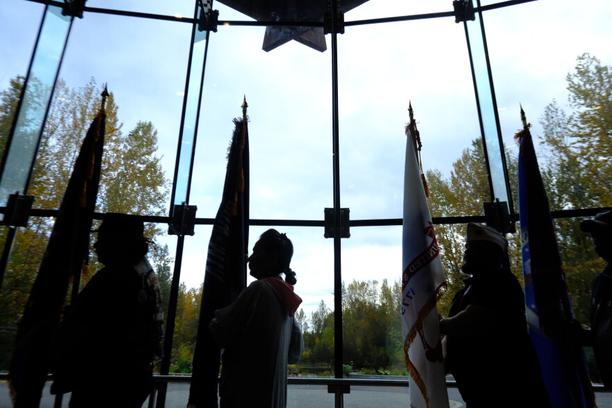A procession of Alaska Native veterans carry the flags inside the the Alaska Native Heritage Center on Sept. 27, 2026.