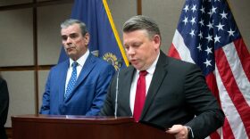 Ryan Kriegshauser, right, is part of a team of federal attorneys suing Kansas to block the state law that offers in-state tuition to Kansas students attending Kansas universities if they don't have lawful immigration status. Kriegshauser, the U.S. Attorney for the District of Kansas, appears with a Wichita police sergeant, left, at an April 21, 2026, news conference at the Robert J. Dole Federal Courthouse in Kansas City, Kansas.
