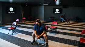 A man waits to get his Covid-19 vaccine during a vaccination event hosted by Miami Heat at FTX Arena in Miami, on August 5, 2021. (Photo by CHANDAN KHANNA / AFP) (Photo by CHANDAN KHANNA/AFP via Getty Images)
