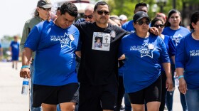 Family members of Nicolas Toledo join thousands to participate in a community walk through downtown Tuesday on the one-year anniversary of the Highland Park mass shooting. Toledo, 78, was one of seven people killed in the shooting that left more than three dozen others injured during Highland Park’s 2022 Fourth of July parade.