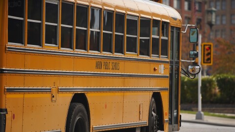 An Akron Public Schools bus drives through Downtown Akron.