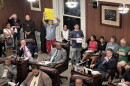 Observers listened from the rear of the New Bedford City Council chamber Tuesday as the council debated motions on the use of Flock surveillance cameras in the city.