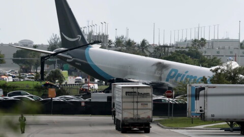 An Amazon cargo plane is seen after it crashed at Miami International Airport on Sunday in Miami. The Federal Aviation Administration said Prime Air Flight 7598 overran the runway while landing around 2 p.m. ET after departing from San Juan, Puerto Rico.