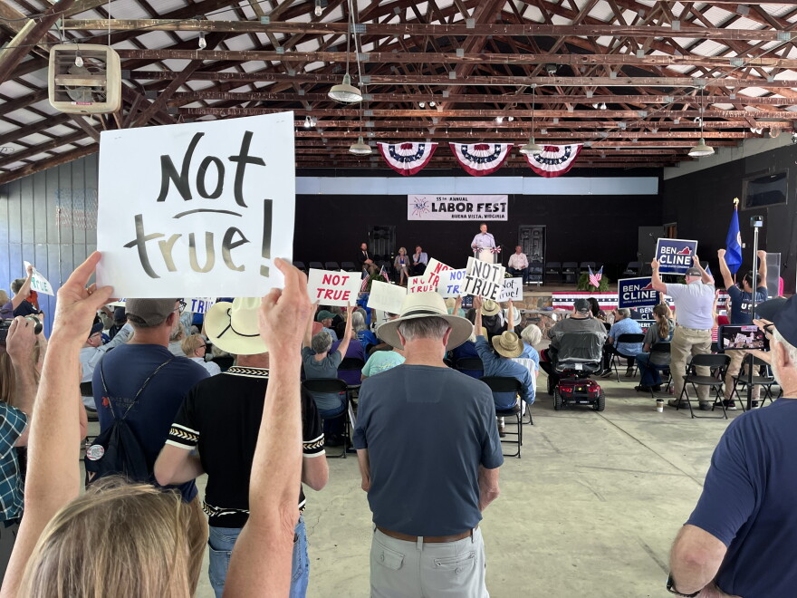Democratic supporters in the audience react to Republican Representative Ben Cline's remarks at the Labor Day festival in Buena Vista.