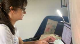 Kamice Klein sits at her computer desk in her East Orlando bedroom preparing for the first day of school. 