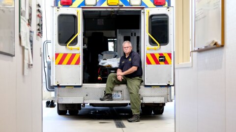 Fire Chief Mike Bucy poses for a photo in an ambulance on Thursday, Aug. 7, 2025, at Stevens County Fire District 1 Station 2 in Loon Lake, Washington. Stevens County EMS and Trauma Care Council are facing significant challenges due to limited funding and persistent staffing shortages.