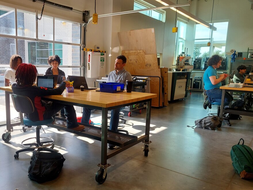 A group of students at Energy Institute High School work on a group project in teacher Calvin Mark’s senior capstone class.