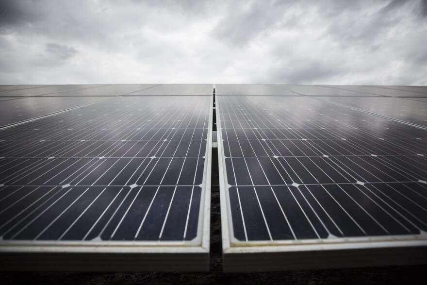 A row of houses with solar panels on the roof
