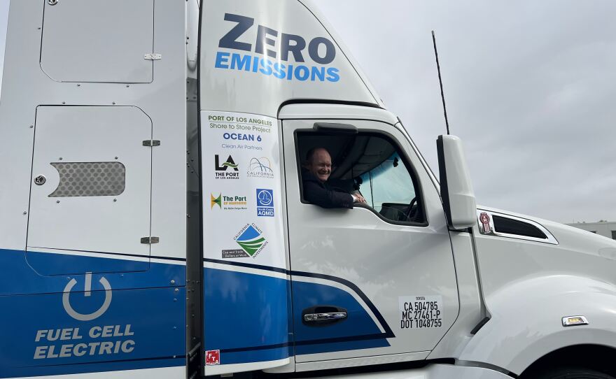 Sen. Chris Coons sits in a hydrogen fuel-cell truck, that emits no fossil fuels, and almost no odors or noise.