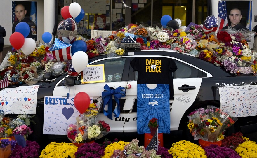 Flowers and balloons were placed at a memorial for Bristol Police Officers Sgt. Dustin DeMonte, 35, and Officer Alex Hamzy, 34, at Bristol Police Department In Bristol, Connecticut, on Oct. 14, 2022. DeMonte and Hamzy were killed in the line of duty on Oct. 12, 2022.