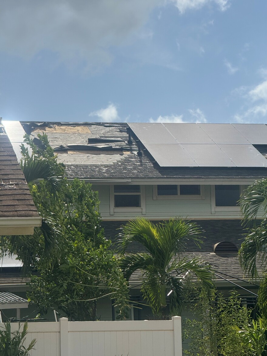 Shingles and a solar panel were ripped off a neighbors' roof during Hurricane Lala.