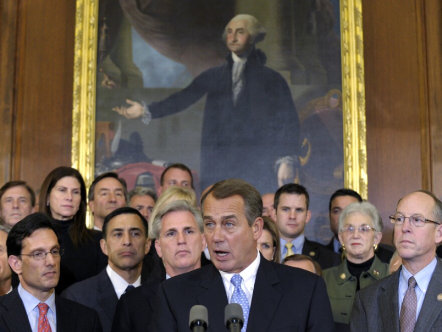 House Speaker John Boehner of Ohio, surrounded by Republican House members, speaks during a news conference on Capitol Hill on Tuesday.