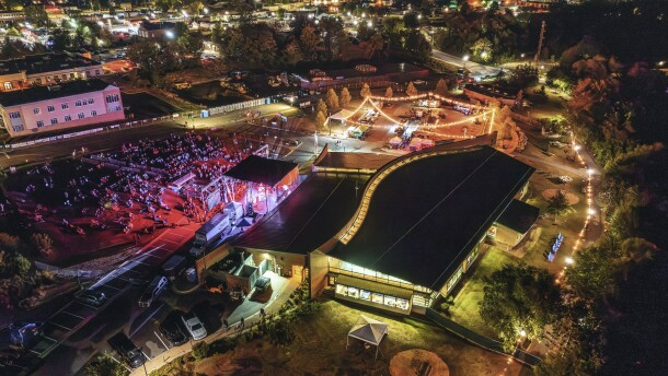 An overhead view shows the crowd and stage of Grand Rapids Riverfest at night under the lights on Sept. 6, 2025.