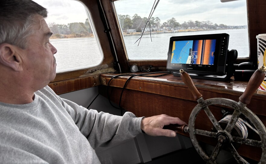 Ralph Bonniville looks at radar to steer toward derelict fishing gear in the York River on Monday, Feb. 10, 2025.