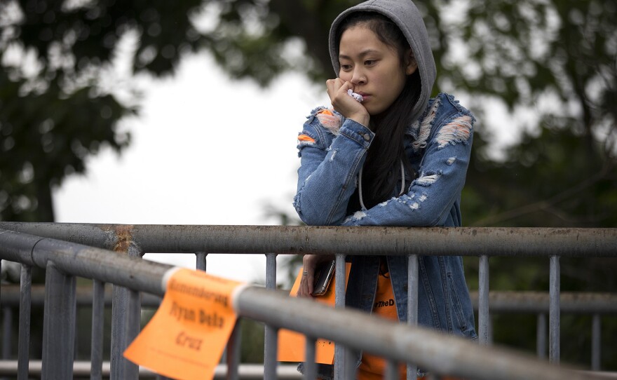 Jasmine Nguyen, 18, stands on a bridge overlooking Rainier Ave. South during a demonstration on Friday, June 8, 2018, outside of Franklin High School in Seattle.