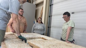 University of Alaska Anchorage public health professor Philippe Amstislavski, far left, and Robbin Garber-Slaght, a mechanical engineer at the National Renewable Energy Laboratory in Fairbanks, far right, discuss how to disassemble one of their so-called "celium walls" Aug. 6, 2025, in Fairbanks, Alaska.