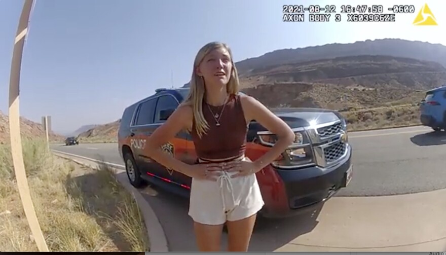FILE - In this image taken from police body camera video provided by the Moab Police Department, Gabrielle "Gabby" Petito talks to a police officer after police pulled over the van she was traveling in with her boyfriend, Brian Laundrie, near the entrance to Arches National Park on Aug. 12, 2021. The families of Petito and Laundrie have reached a $3 million settlement in a wrongful death lawsuit filed after authorities concluded he strangled her during a cross-country trip in August 2021.