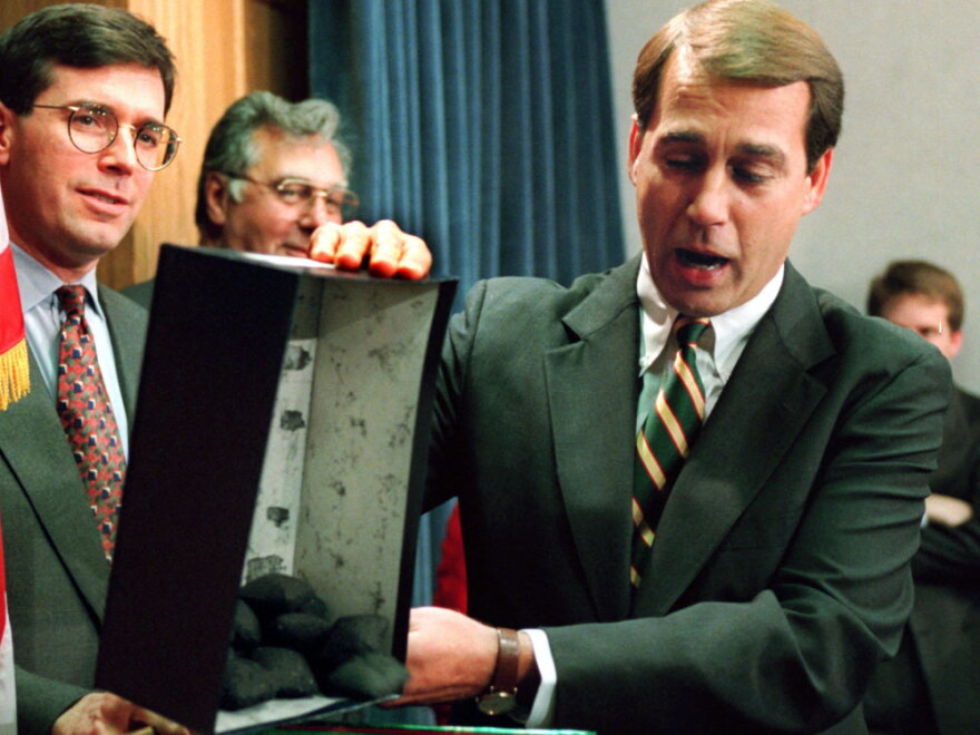 Boehner dumps out the coal that he  called a Christmas gift to President Clinton during a news  conference to discuss the federal budget in 1995. When Newt Gingrich became House speaker that year, he took Boehner into the inner circle of GOP leaders.