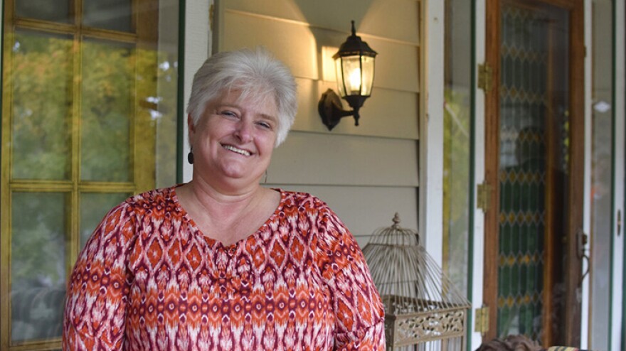 Tami Wenning poses outside a home in Greensburg, Ind., on Friday, Oct. 22, 2021. Wenning and her husband, Dan, will offer free babysitting and will fill in on Grandparents Day at school as part of a new incentive program to attract remote workers to the southeastern Indiana city.