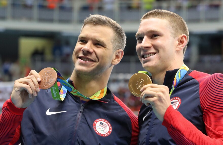 The United States' Ryan Murphy, right, and bronze medalist David Plummer celebrate with their medals after the men's 100-meter backstroke at the swimming competitions at the 2016 Summer Olympics, Monday in Rio de Janeiro, Brazil.