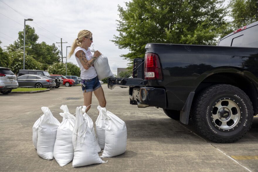In preparation for possible Tropical Storm Dexter, New Orleans resident Carla Galore loads sandbags into her truck during a distribution event at the Andrew P. Sanchez & Copelin-Byrd Multi-Service Center in the Lower 9th Ward, Wednesday, July 16, 2025. The distributions were offered across the city through a joint effort by the Department of Public Works, Office of Homeland Security and Emergency Preparedness and New Orleans City Council.