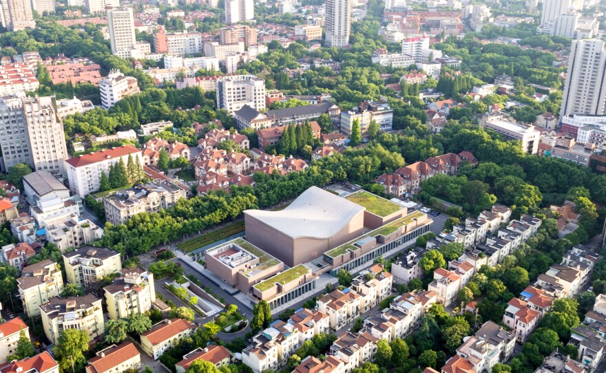 The Shanghai Symphony Hall (center) sits like an outsize saddle in the midst of the Chinese metropolis. The concert venue opened just a few years ago.