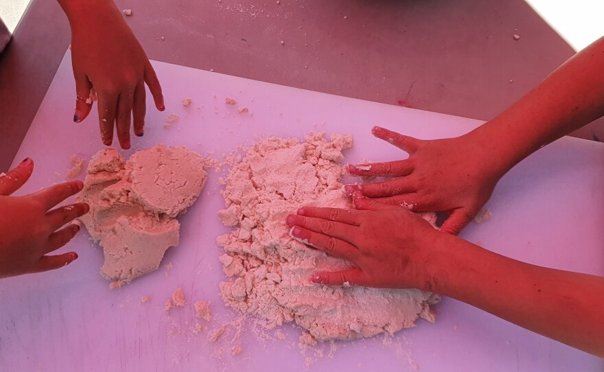 Many hands make light work when prepping the masa for tortillas.