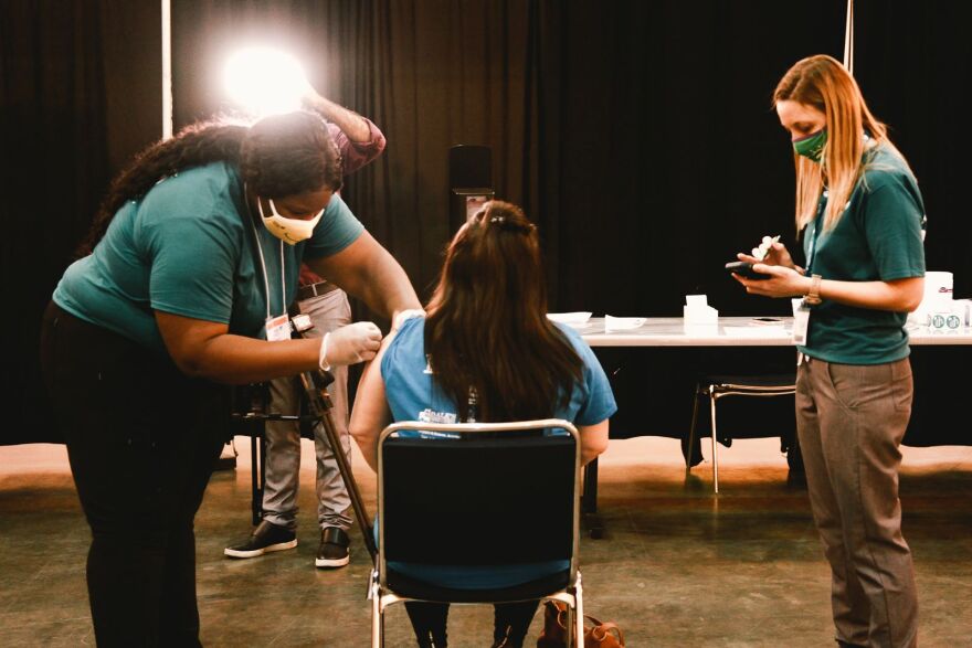 A woman receives a COVID-19 vaccine at the Ernest N. Morial Convention Center. March 4, 2020.