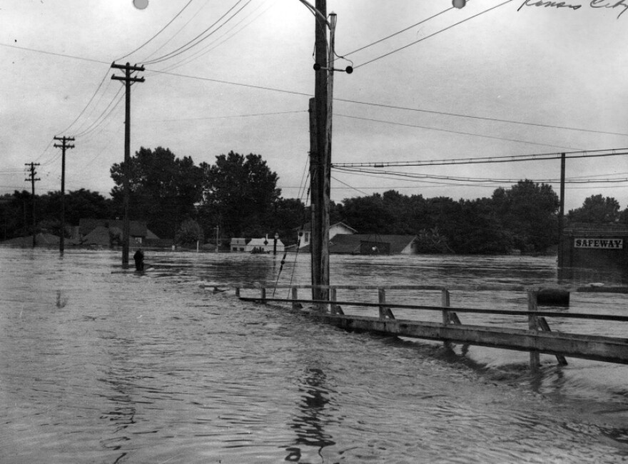 High water at Kansas Avenue and Mill Street in the Armourdale District, Kansas City, Kansas, as an overflowing Kansas River submerges houses and stores. 