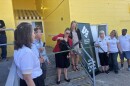 A ceremonial ribbon-cutting.