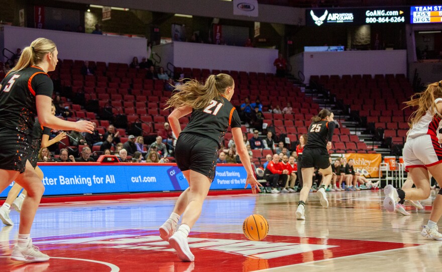 Girls high school basketball players inside an arena