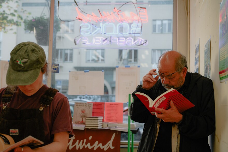 Attendees explore books for sale at a final farewell event for Eastwind Books in April 27.