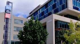 This is a picture of the NPR headquarters building in Washington, D.C. On the left side of the image is a large "NPR" sign. 