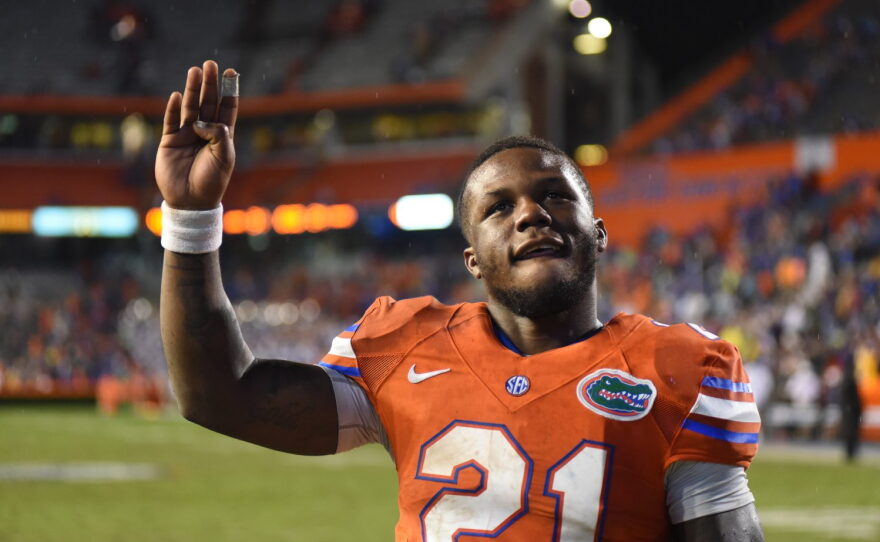 Florida running back Kelvin Taylor (22) waves to the fans as he exits the field after the game.